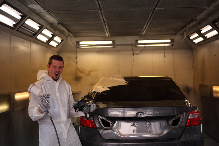 Student practicing paint spraying during an auto body training course in Surrey