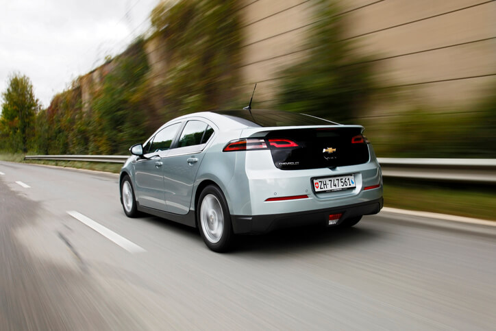A student test-driving an EV after completing auto mechanic school training.