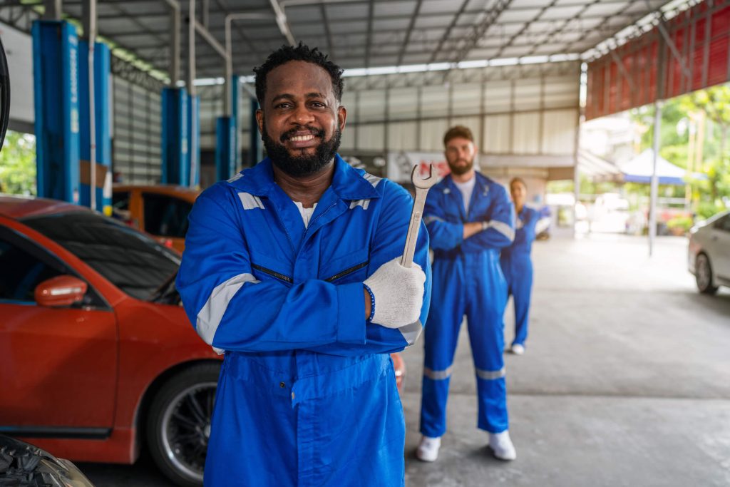 An auto mechanic training students, gaining hands-on experience in the workshop at ATC Cambridge.