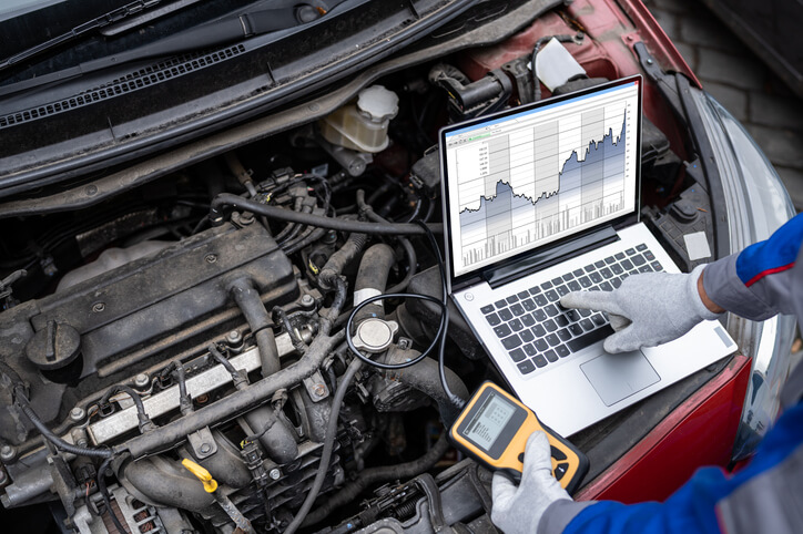 An auto mechanic school student practicing diagnostic skills