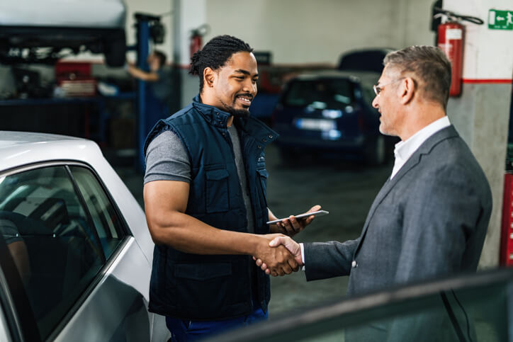 An electric vehicle mechanic providing customer service at an automotive school.