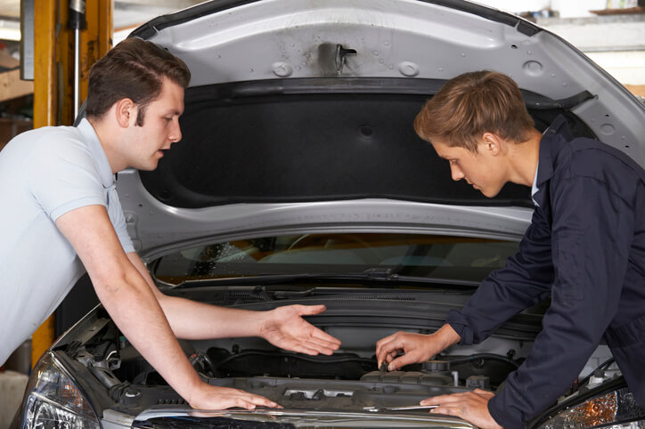 An auto mechanic course student learning diagnostic techniques during hands-on training.
