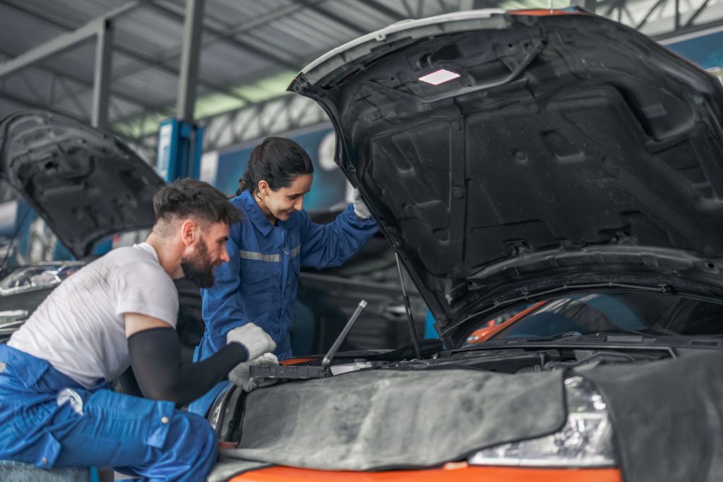 Auto mechanics working on a vehicle