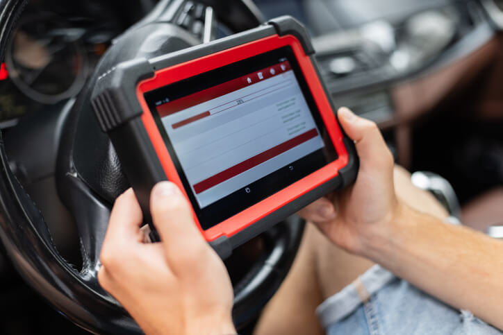 A student at ATC auto mechanic school in Surrey, analyzing ignition timing on a diagnostic scan tool