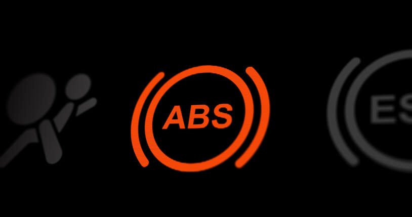 An ABS warning light used in auto mechanic school training to teach students how braking electronics affect pedal response.