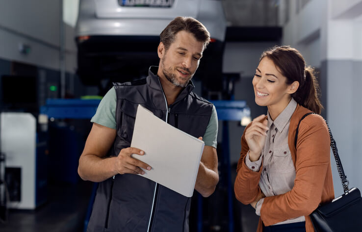 An instructor guiding a student through an engine diagnostic exercise as part of hands-on auto mechanic training.