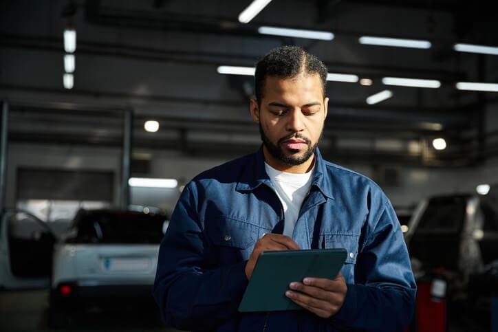 A mechanic completing repair documentation at ATC auto mechanic school in Surrey