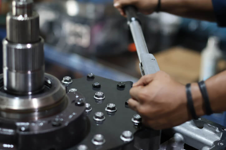 A technician applying manufacturer torque specs in an automotive service technician program