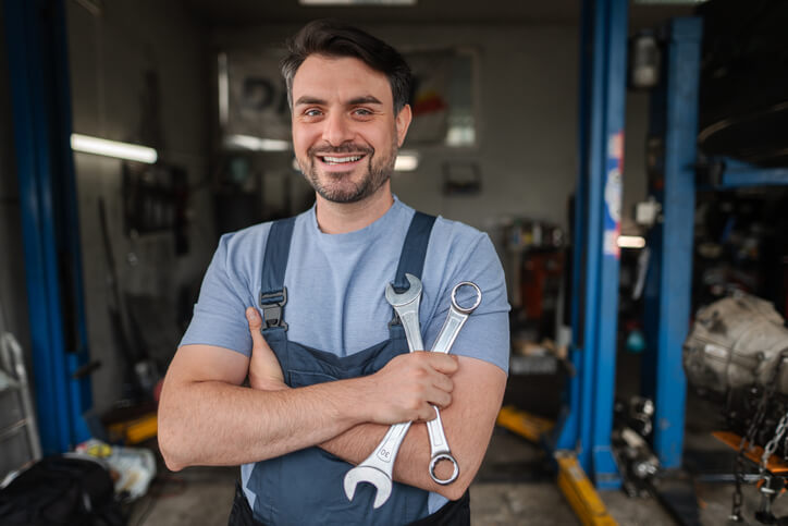 A certified automotive service technician in a professional repair facility representing Red Seal trade standards in Canada