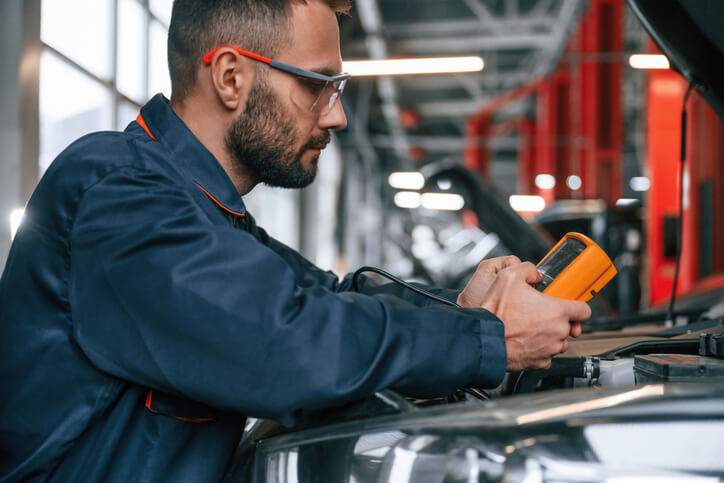 A student at an auto mechanic school is diagnosing a charging system problem