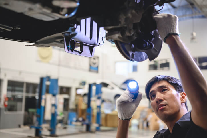 Automotive student inspecting differential housing in a workshop