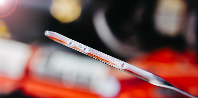 Close-up of a dipstick showing proper oil level markings