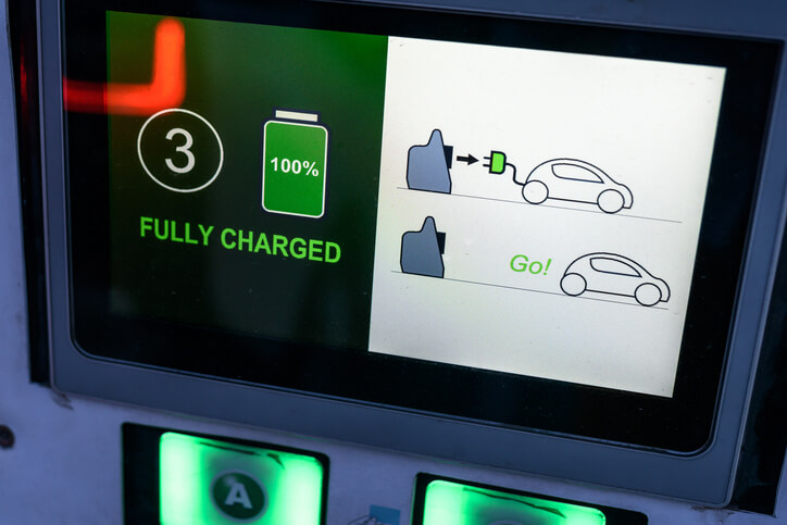 A charging station displaying DC fast charging speed and battery level