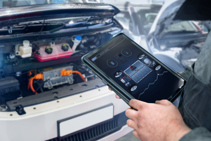 Technician analyzing battery data using EV diagnostic software
