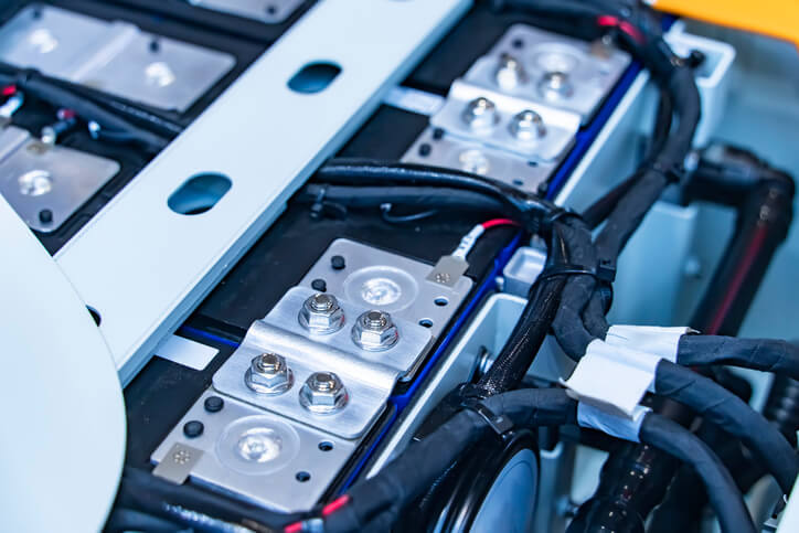 A close-up of battery management system modules and EV battery wiring