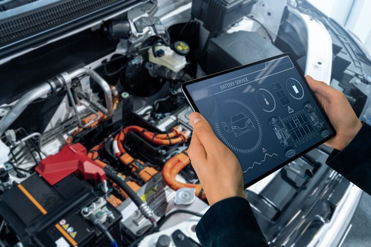 A technician using diagnostic software to analyze battery management system data