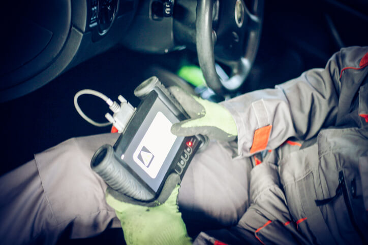 A technician using a scan tool to diagnose an electronic braking system