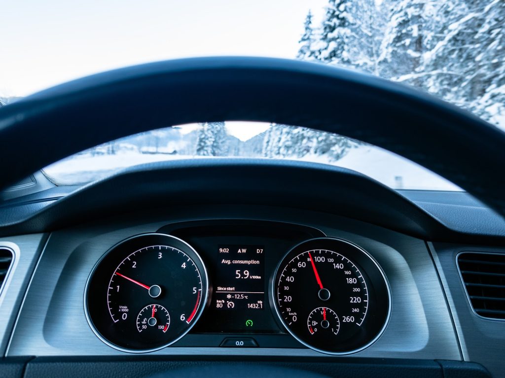An electric vehicle dashboard displaying reduced range in cold weather