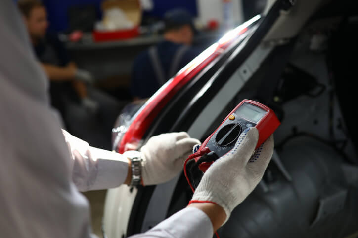 A technician performing an insulation resistance test on an EV system