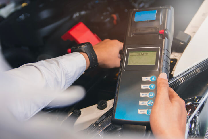 An auto mechanic course graduate performing battery registration using a diagnostic scan tool