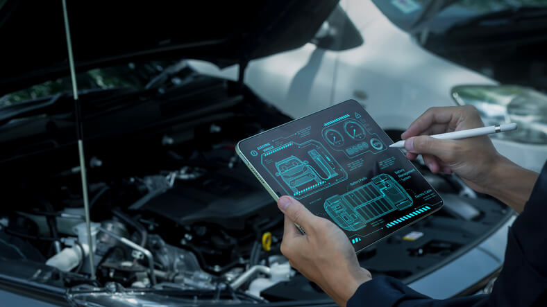A technician diagnosing power electronics in an EV