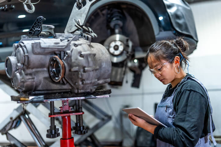 Technician inspecting an EV motor and drivetrain during diagnostics