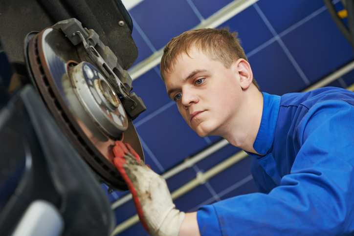 A student in automotive training learning brake diagnostics procedures