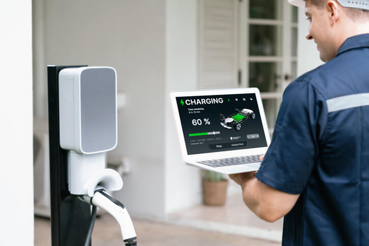 Technician testing DC fast charging functionality after charging port replacement