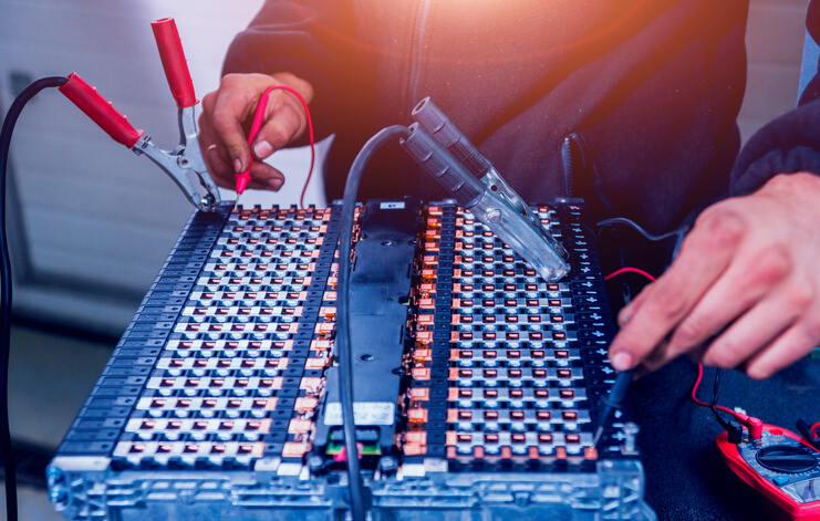 Student learning EV battery testing procedures during hybrid technology training