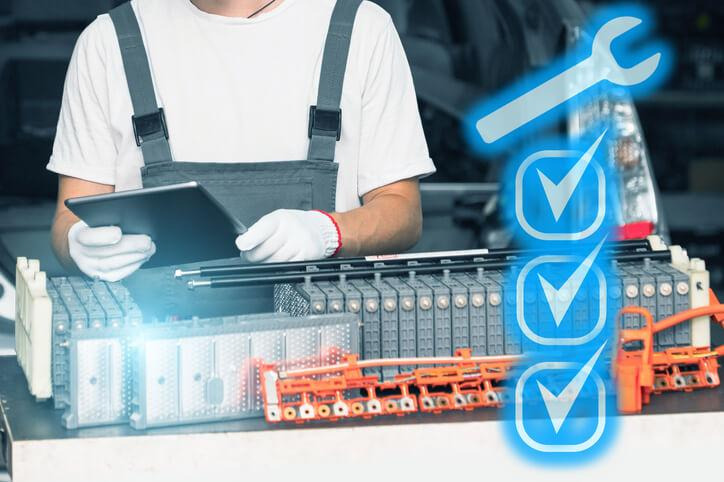 A technician follows high-voltage safety procedures before servicing a hybrid battery pack