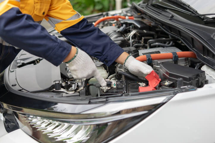 A technician is inspecting a hybrid battery system
