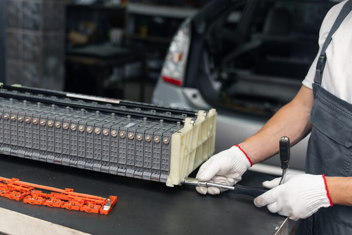 A mechanic servicing a hybrid battery pack
