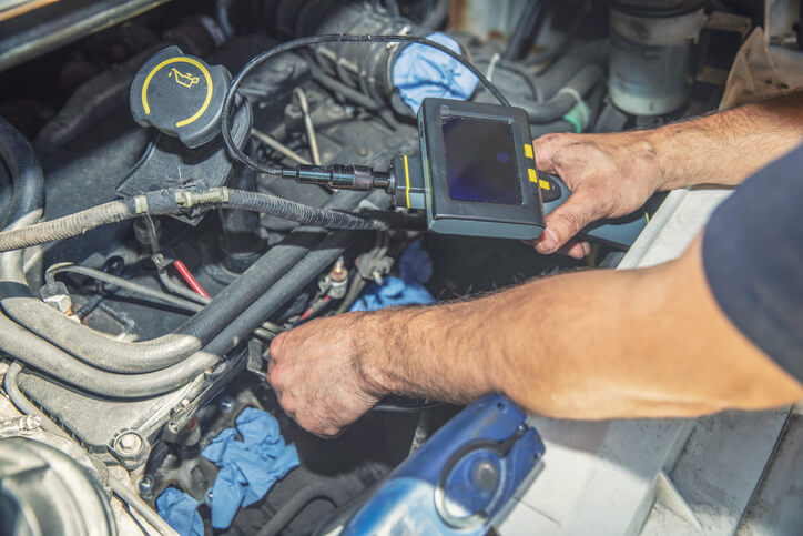 A mechanic using a scan tool to diagnose airflow sensor problems