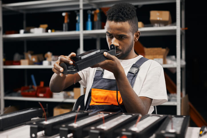 EV technician studying solid-state battery technology components