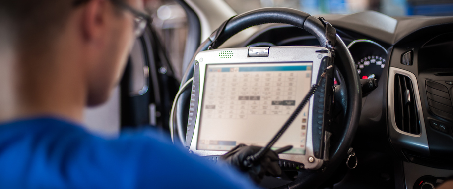 A technician using diagnostic equipment to analyze engine timing data