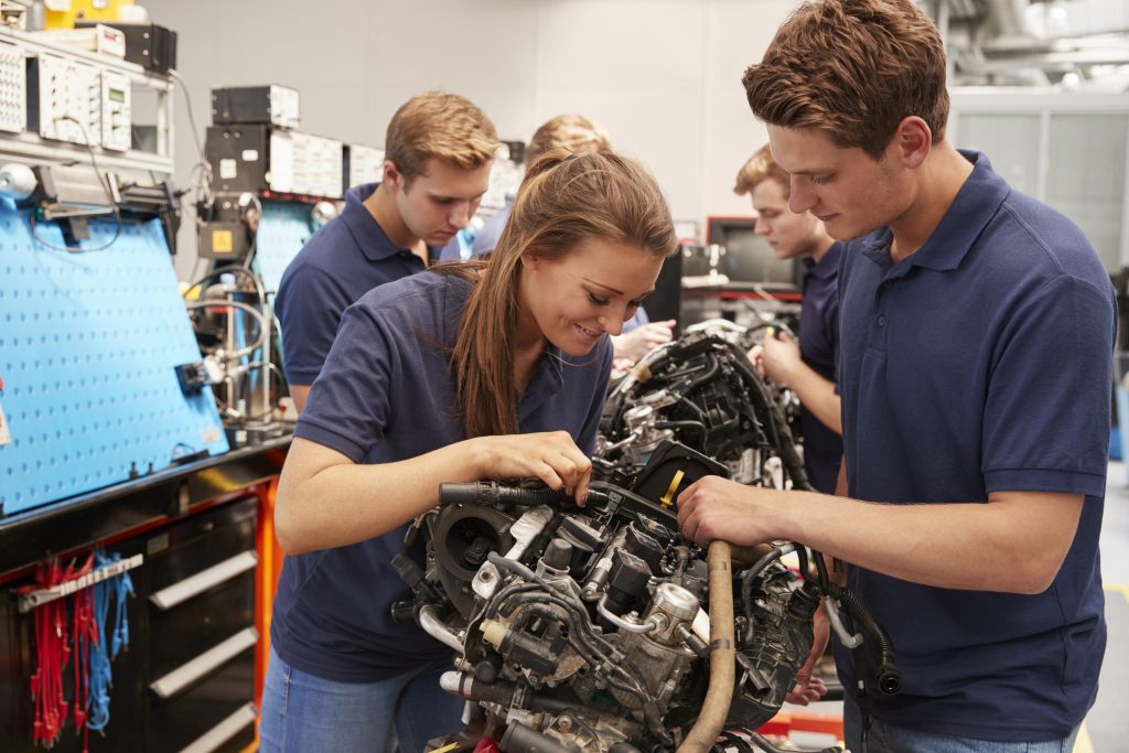 An automotive training student learning about engine designs and performance characteristics