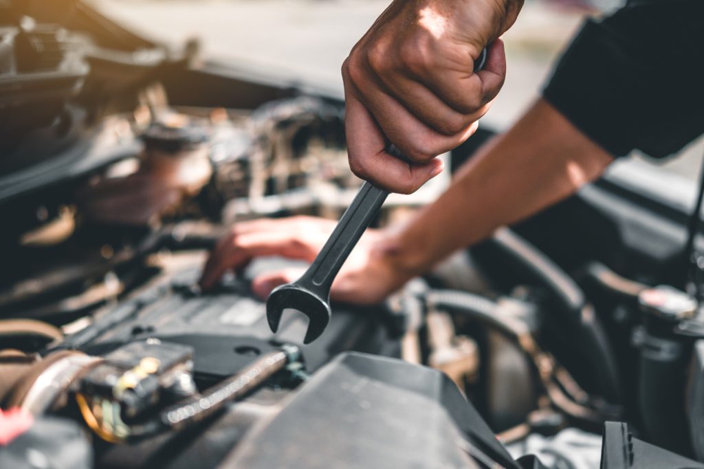 A technician is inspecting transmission components in a repair facility