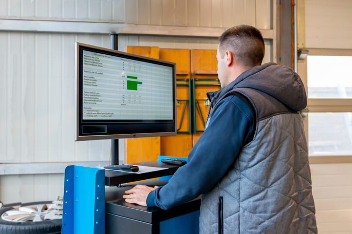 A technician analyzing engine performance data from a dynamometer session
