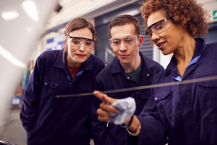 An automotive training student learning about carbureted engine choke systems