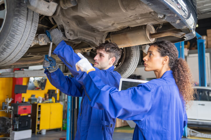 An automotive training student learning suspension diagnostics and repair procedures