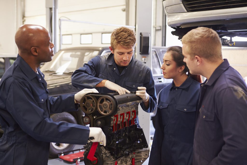 Automotive training students learning how engine power is transferred through a transmission