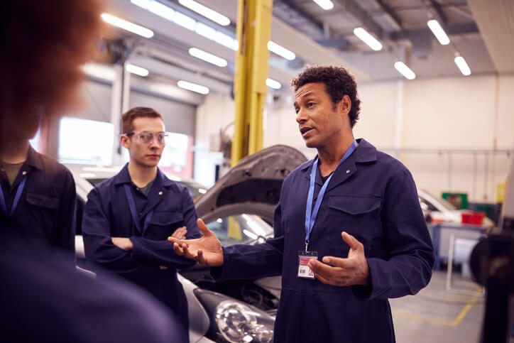 An automotive instructor explaining electronic engine management to students