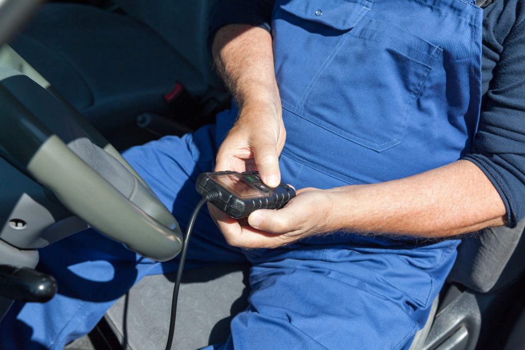 A technician diagnosing an anti-lock braking system with a scan tool