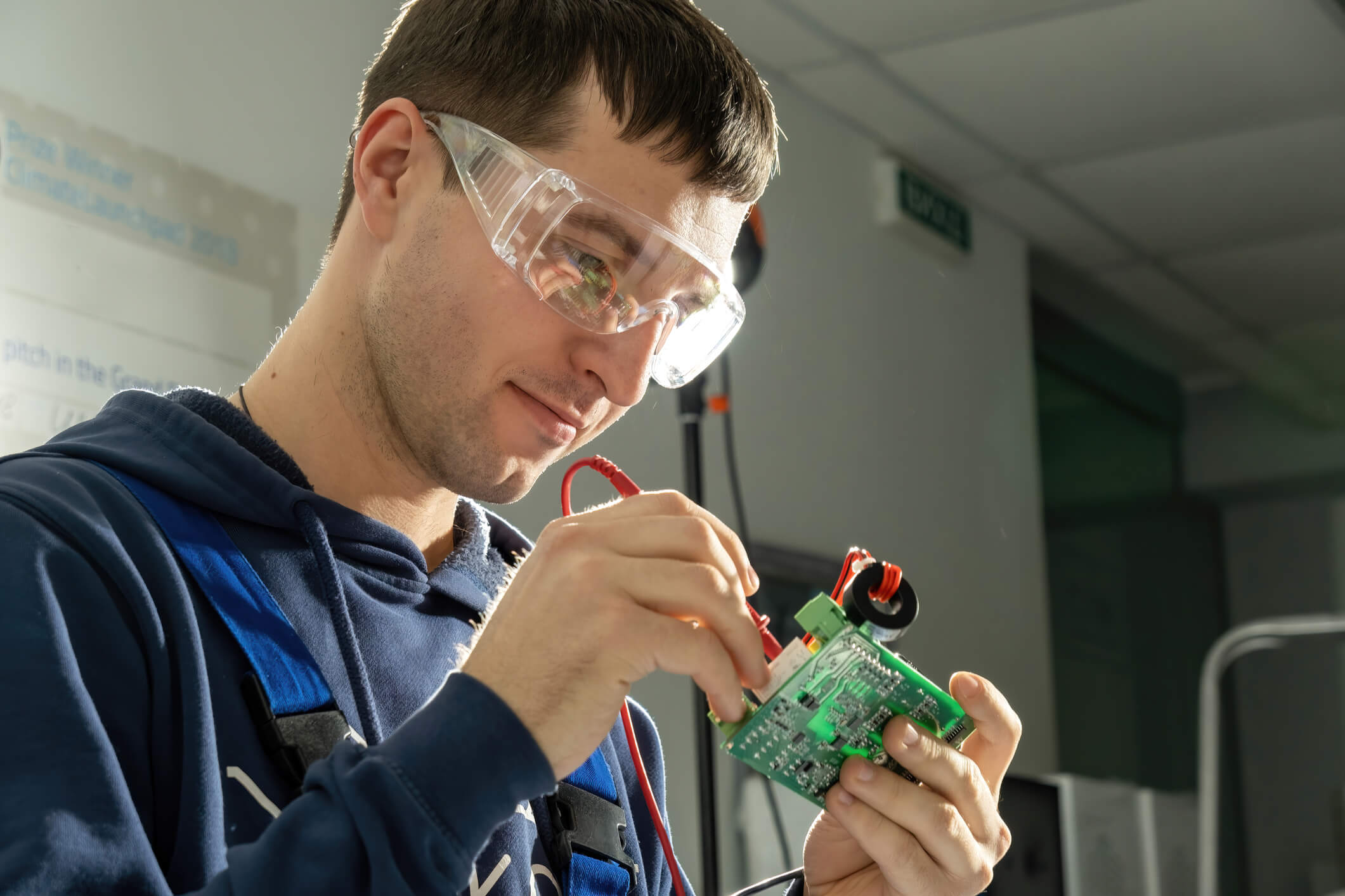 Student learning about a DC-DC converter in an electric vehicle training lab
