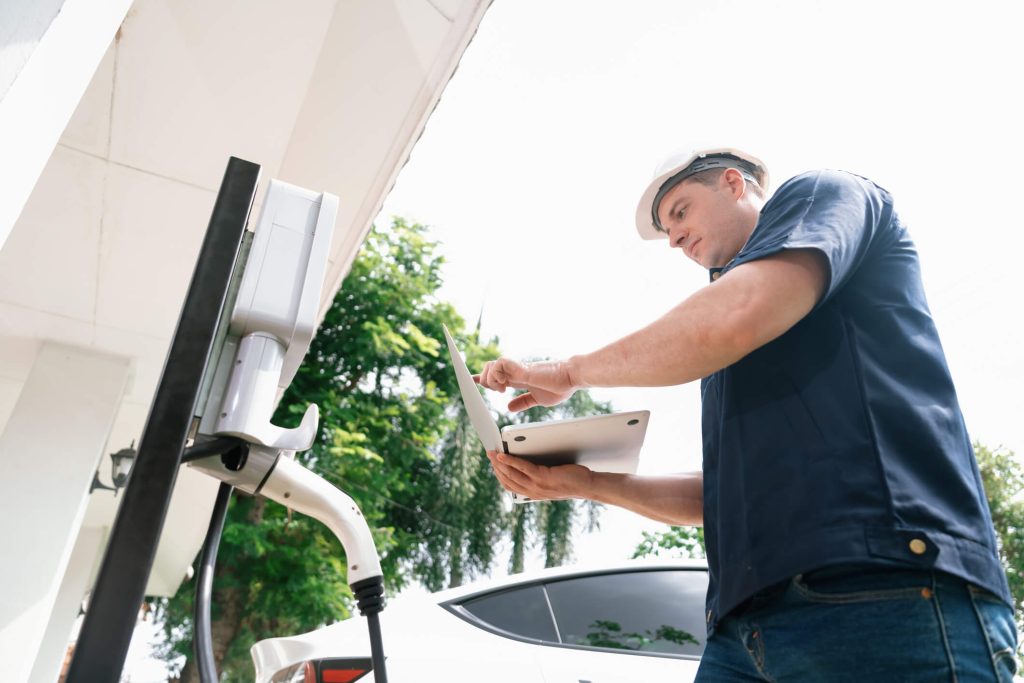 Technician inspecting an EV low-voltage electrical system