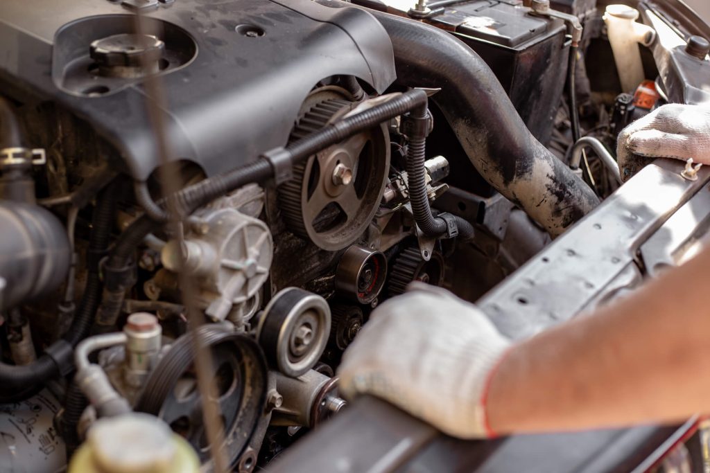 A technician is inspecting engine timing components in a vehicle engine