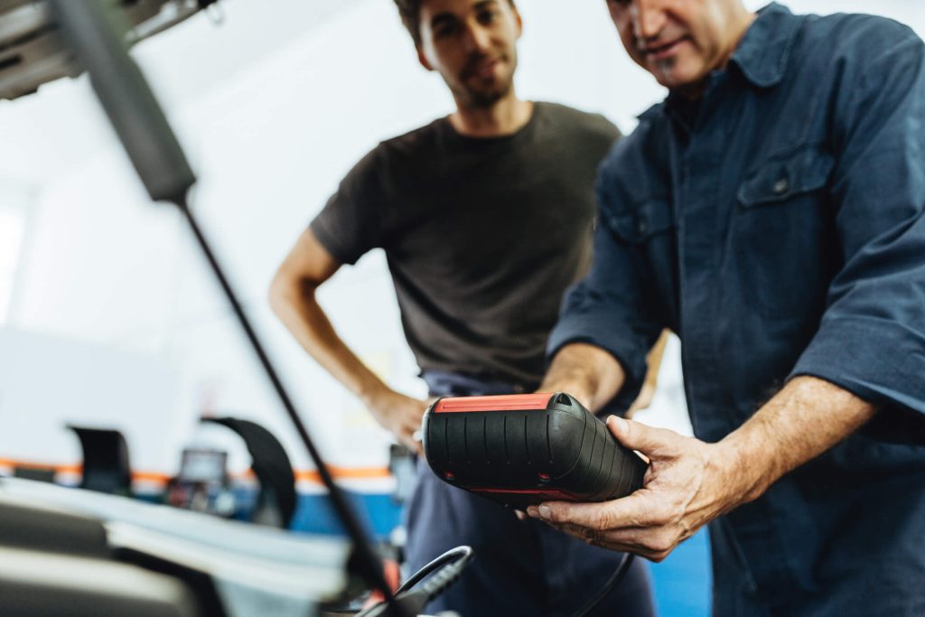 Instructor explaining ignition timing using engine diagnostic equipment