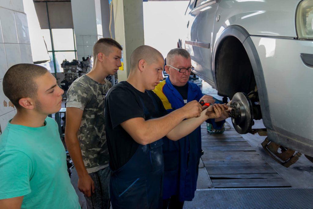 Instructor demonstrating brake service techniques during mechanic training