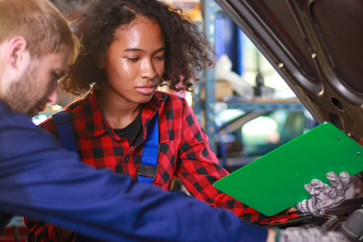 A student learning transmission fluid specifications at an automotive school