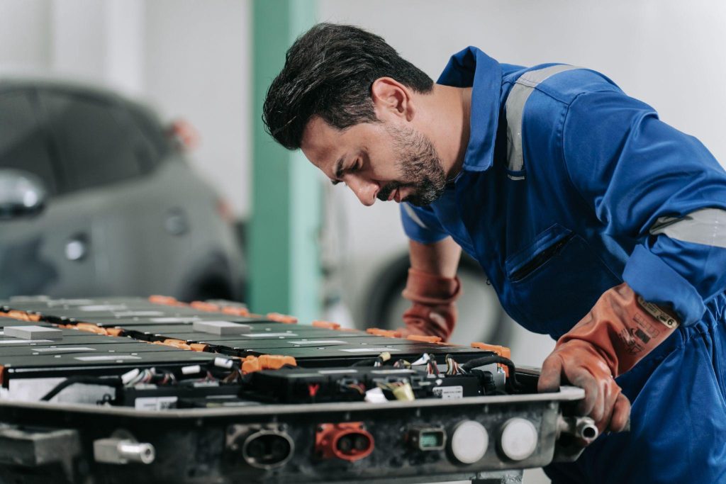 Future EV mechanic inspecting an electric vehicle battery cooling system